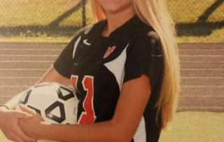 Amanda--female caucasian high school student holding a soccer ball.