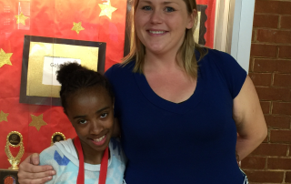 Mrs. Lohrmann standing with one of her fifth grade students.