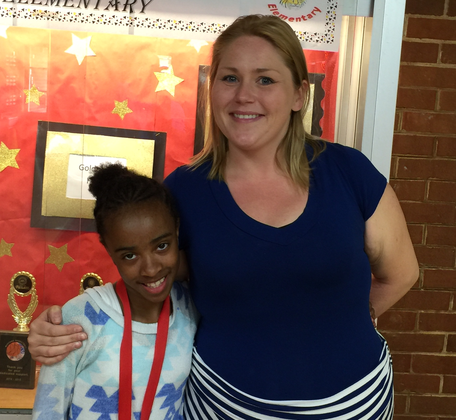 Mrs. Lohrmann standing with one of her fifth grade students.