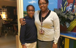 Maxwell standing next to his fifth grade teacher Ms. Tanya