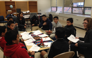 Group of middle school boys talking in circle as part of the El Joven Nobel program