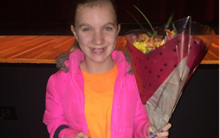 Fifth grade girl holding flowers