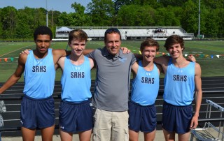 Josh Carroll stands in a broup of four high school boys on the SRHS track team.