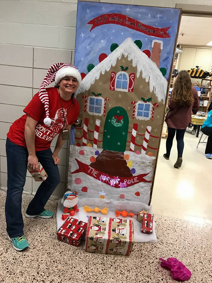 Marlene Kramer standing in front of her classroom door decorated for the holidays