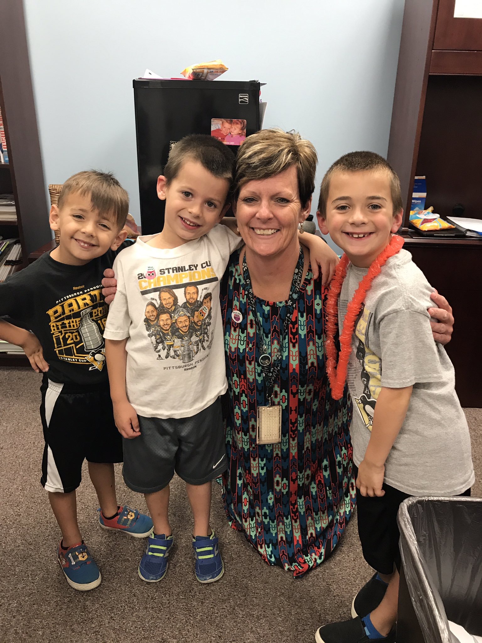 Lisa Koennel standing with three elementary school boys