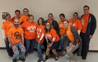 Group Photo of the Glen Burnie High School English Department wearing Orange Shirts for Unity Day