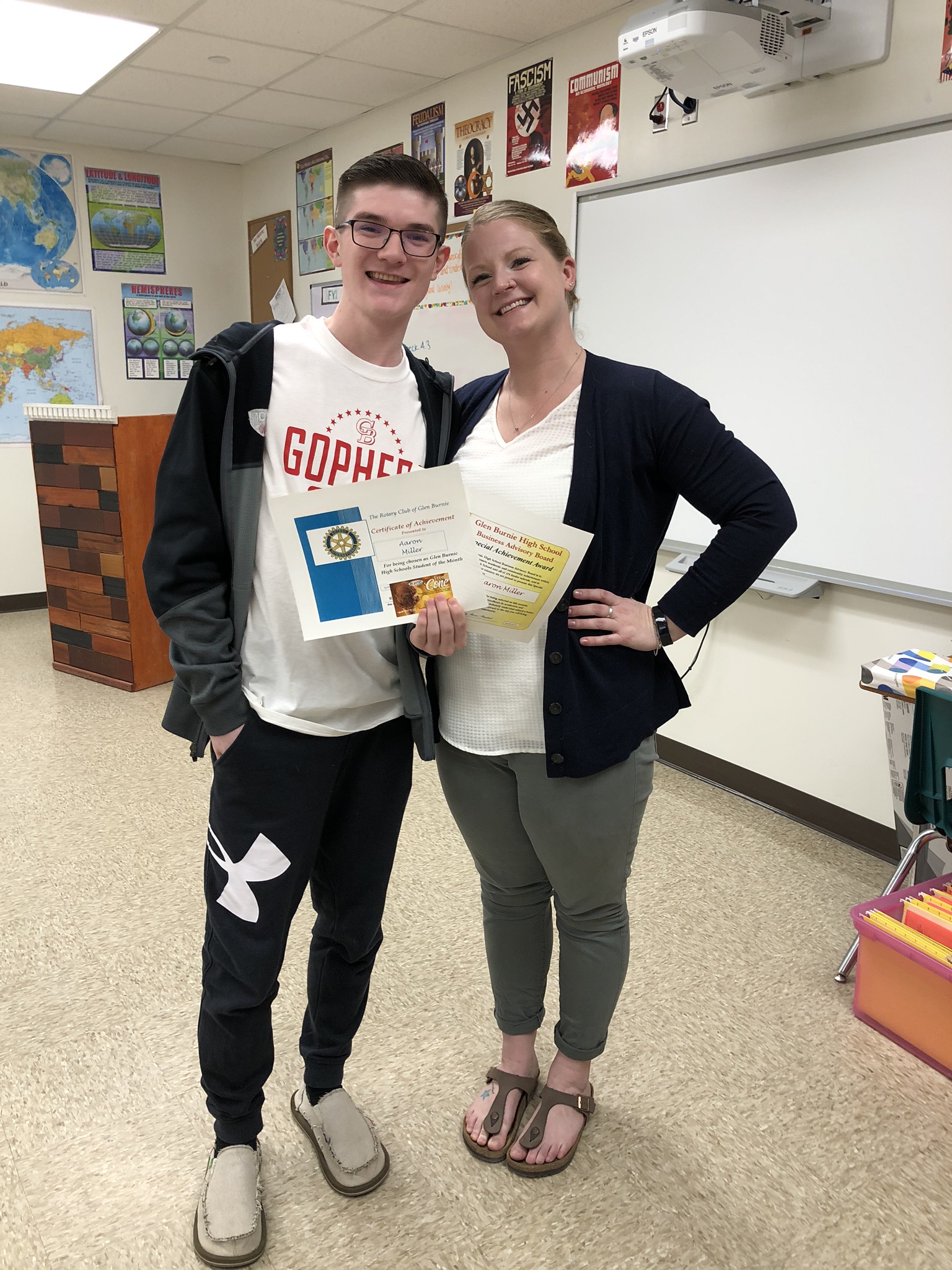 Aaron stands next to his teacher Ms. Burdette